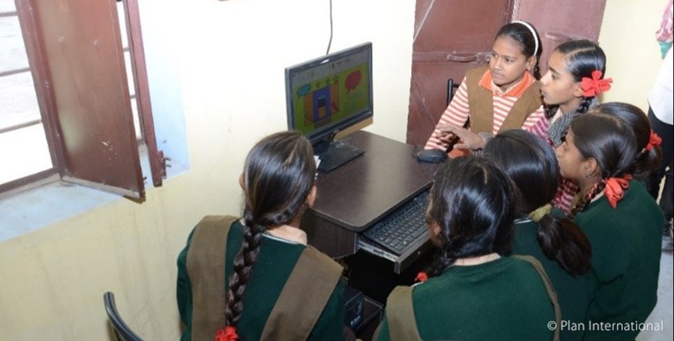 Girls studying with computer in India.